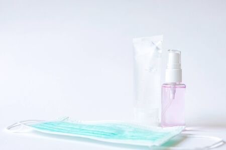 Selective focus of Alcohol gel,spray for hand sanitizer with surgical face mask on white background. Personal hygiene to protect and prevent virus, illness during corona virus out break covid 2019.の写真素材