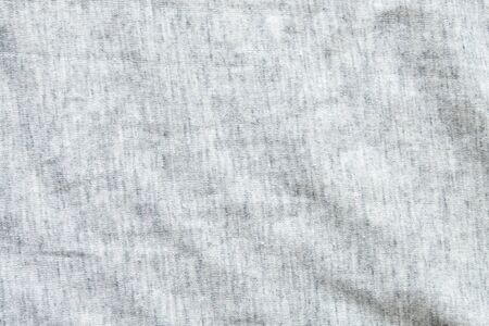 Close up shot to see the detail of heather grey knitted fabric made of synthetic fibres background. abstract wallpaper clothing or soft textile with copy space for text.の写真素材