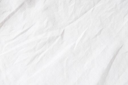 Wrinkled White fabric close up shot of good quality Cotton and polyester shirt. formal wear for office worker . Background texture concept with copy space for text.の写真素材