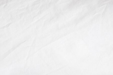 Wrinkled White fabric close up shot of good quality Cotton and polyester shirt. formal wear for office worker . Background texture concept with copy space for text.の写真素材