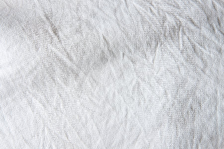 Close up shot of white wrinkled cotton fabric which show textile garment detail. Idea for background or wallpaper.の写真素材
