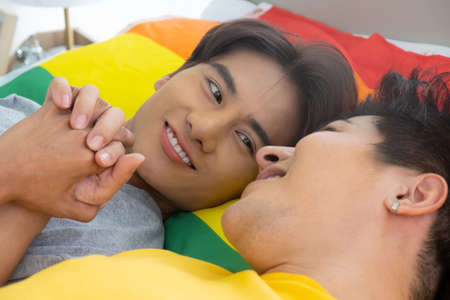 Asian gay homosexual couple hug and embracing on the bed.  Gender equality and right concept, playful and romantic moment.の写真素材