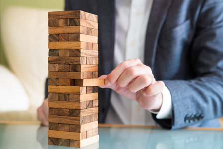 Selective focus at wood brick. Business people dress in formal suit taking risk and make decision to...