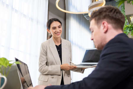 Selective focus at computer screen. Caucasian business women dress in formal suit holding laptop...