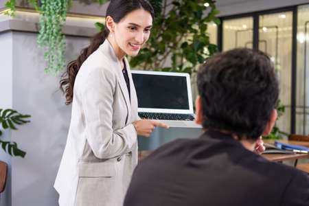Selective focus at computer screen. Caucasian business women dress in formal suit holding laptop...