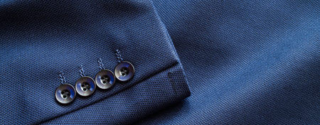High resolution with details, banner shot of formal dark blue wool suit fabric texture. with button decoration under light and shadow ambient. Ideal for background or wallpaper.の写真素材