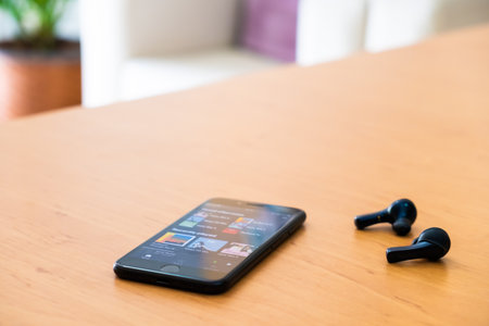 Bangkok Thailand 14 Aug 2020. Smartphone device on top of the wood table open Spotify music...