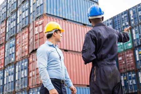 Selective focus at African black worker while talk and having discussion with supervisor and inspect...