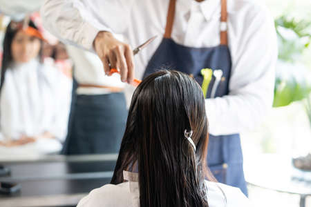 Close up shot at women hair before do hair cut and hair dresser and treatment while styling hair for...