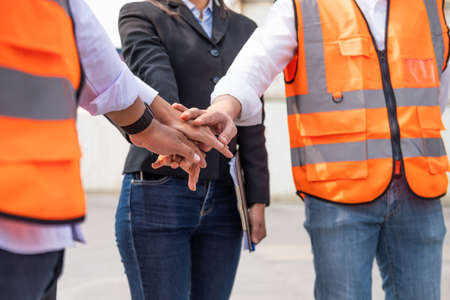 Unidentified group of multi mix race worker with supervisor  holding hand to cheer up and encourage...