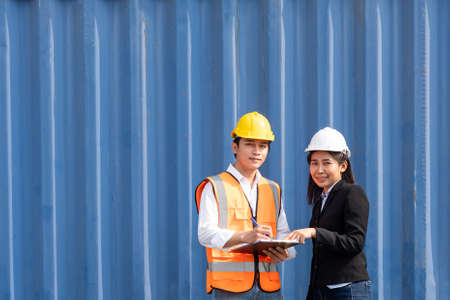 Selective focus at face Asian men worker. industrial warehouse container worker wearing safety...