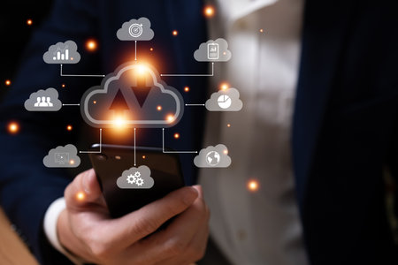 Selective focus at the icon with hand of businessman that holding cloud icon while who using internet and personal cloud storage to keep information and payment data, upload over the internet.の写真素材