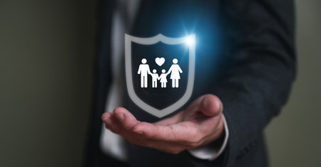 Insurance agent with formal suit using hand to protect customer family from falling wood brick. With icon of the family with shield to prevent the risk and accident. Risk management with insurance.の写真素材