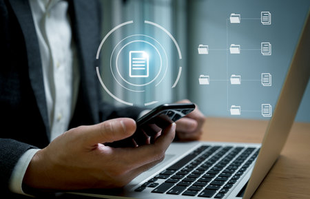 Selective focus at finger point at document icon at laptop computer that being share among working group on cloud storage platform. Technology that allow people to work remotely, online files.の写真素材