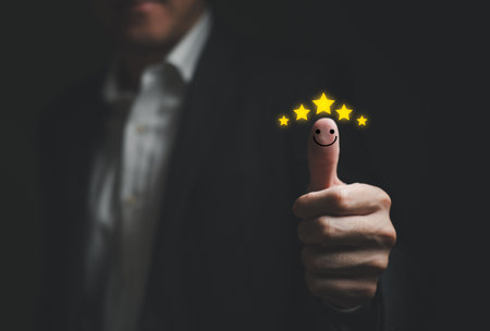 Selective focus at finger of business man while point finger to choose feedback on excellent customer service with five star score with smile. Service evaluation concept with futuristic iconの写真素材