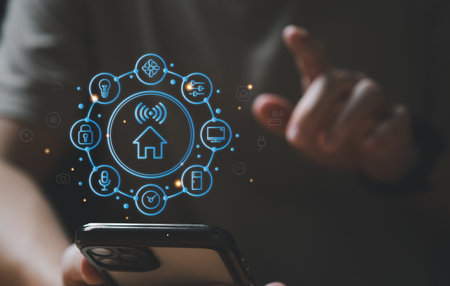 People hand using smartphone or computer laptop to access smart home application from internet wireless connection to control and monitoring smart device inside of the house. Internet of things.の写真素材