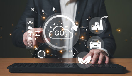 Entrepreneur hand point at digital screen dashboard while control and reduce carbon emission for global friendly business. Business with environment concern, carbon credit and zero emission.の写真素材