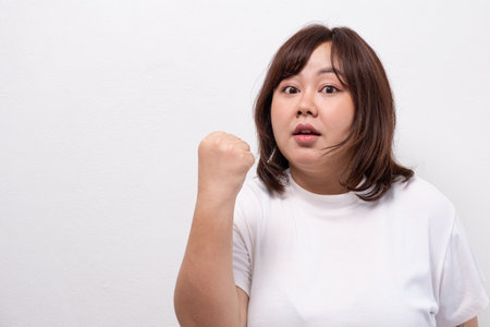 Young beautiful Asian oversize women smile with positive emotion, feeling happy and proud with her...
