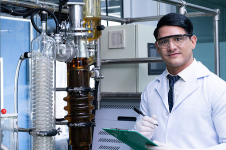 Portrait shot of men scientist while scientist study and examine with chemical or essential oil for medicine inside test laboratory. Chemical engineer work process with copy space for text.の写真素材
