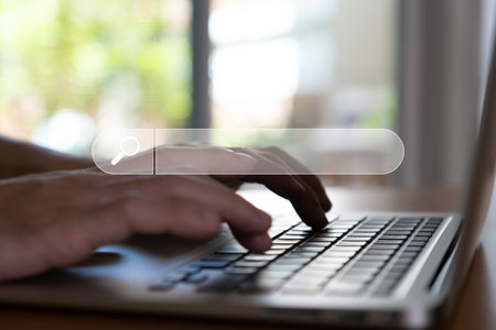 Selective focus at the search box with blurred background of men hand holding digital tablet or laptop computer with internet router while search for information from internet and websiteの写真素材