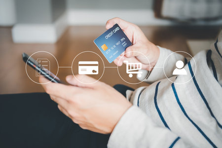 Selective focus at credit card while people use it while purchase for online shopping with smartphone with an illustration icon that show process of buying until deliver order at home.の写真素材