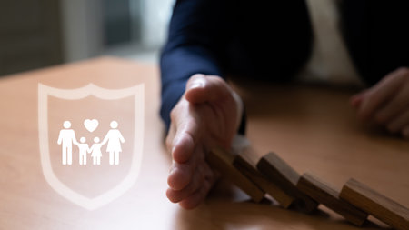 Insurance agent with formal suit using hand to protect customer family from falling wood brick. With...