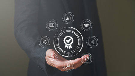 Businessman show thumbs up with icon that show top service quality standard in business or industrial ISO certification. Quality assurance formal concept in organization.の写真素材