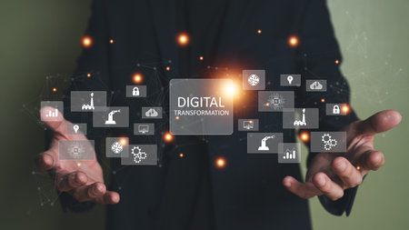 Business person dress in formal suit holding an icon that show the component of Business that do digital transformation for industrial or manufacturing vertical.の写真素材