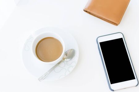 Coffee time in the morning, coffee cup with smartphone and wallets.の写真素材