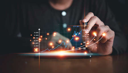 Investor touching growth graph chart and data business strategy digital marketing and payment on digital virtual screen analyze planning business and financial growth up concept.の写真素材