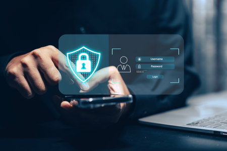 Cybersecurity login and data protection concept: A user's hands type on a laptop keyboard, with a...