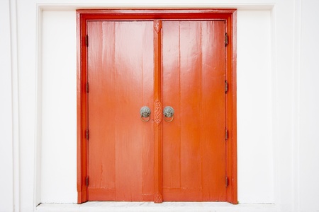 Old thai door with single traditional asian red wooden door closed の写真素材