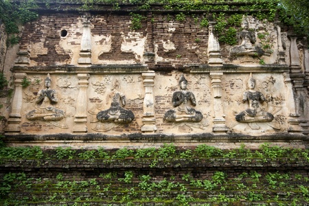 Old statue of Buddha image in the brick wall, north of Thailand の写真素材
