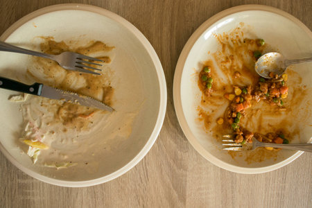 dirty plate from remaining food  on tableの写真素材