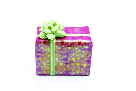 pink gift box with green ribbon bow, isolated on whiteの写真素材