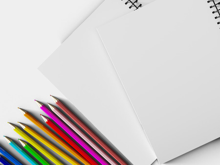 notebook with colored pencils on White background, stationary objectの写真素材