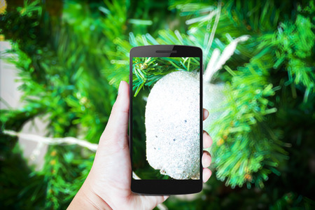 Modern mobile phone in the hand,on blur background imageの写真素材