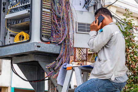 Telephone technician checks the coaxial cable