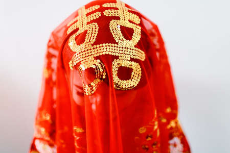 Penang, Malaysia - January 09, 2016 : A bride of a traditional chinese wedding covering her head with a red veil with the words "Prosperity" at Bayan Baruのeditorial素材