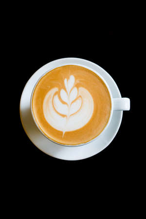Close up of a coffee in a white cup with black backgroundの写真素材