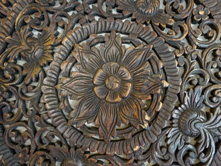Close up of an intricate wood carving of South East Asian inspired cultureの写真素材