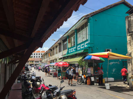 Penang, Malaysia - August 27, 2016 : Typical street view in Penang of shophouses, vendors and motorcycle parking at Georgetownのeditorial素材