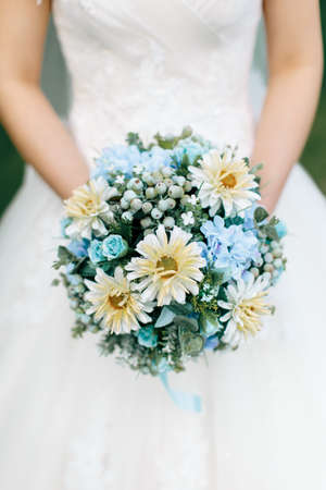 Close up of a wedding bouquet hand held by a wedding brideの写真素材