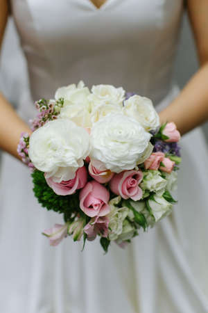 Close up of a wedding bouquet hand held by a wedding brideの写真素材