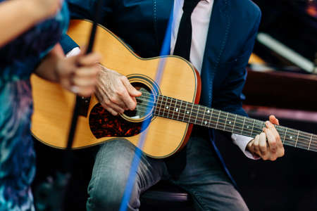 Penang, Malaysia - November 12, 2017 : Close up of a person playing an acoustic guitar during a private function at Batu Feringghiのeditorial素材