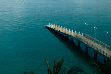 View of a boat landing pier with blue waterの写真素材