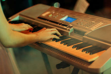 Penang, Malaysia - November 12, 2017 : Close up of a person playing an electronic keyboard during a private function at Batu Feringghiのeditorial素材
