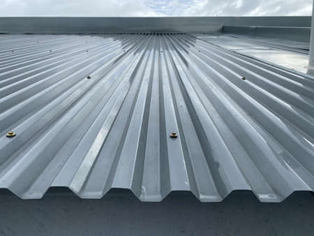 Close up of a corrugated metal deck roof system just installed on a buildingの写真素材