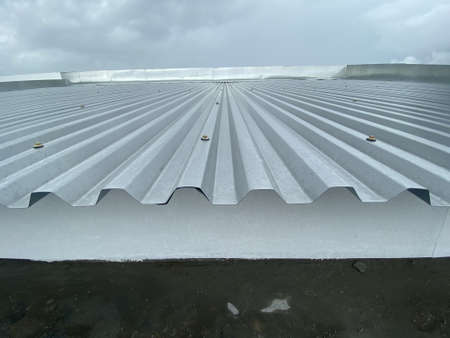 Close up of a corrugated metal deck roof system just installed on a buildingの写真素材