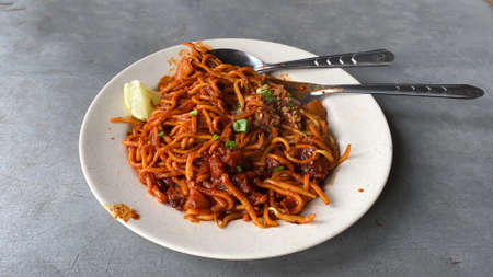 A plate of  "indian mee" or spicy indian dry noodle cooked by a hawker in Penang, Malaysiaの写真素材